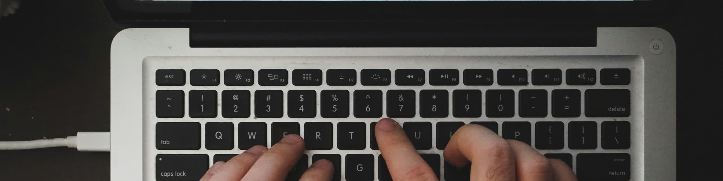 Laptop keyboard with hand typing